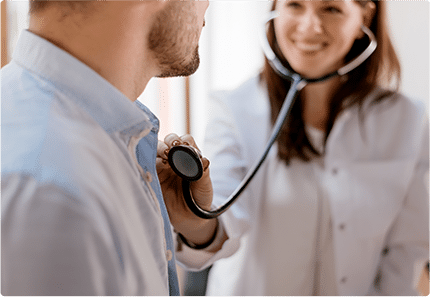 Female doctor checking heartbeat of patient